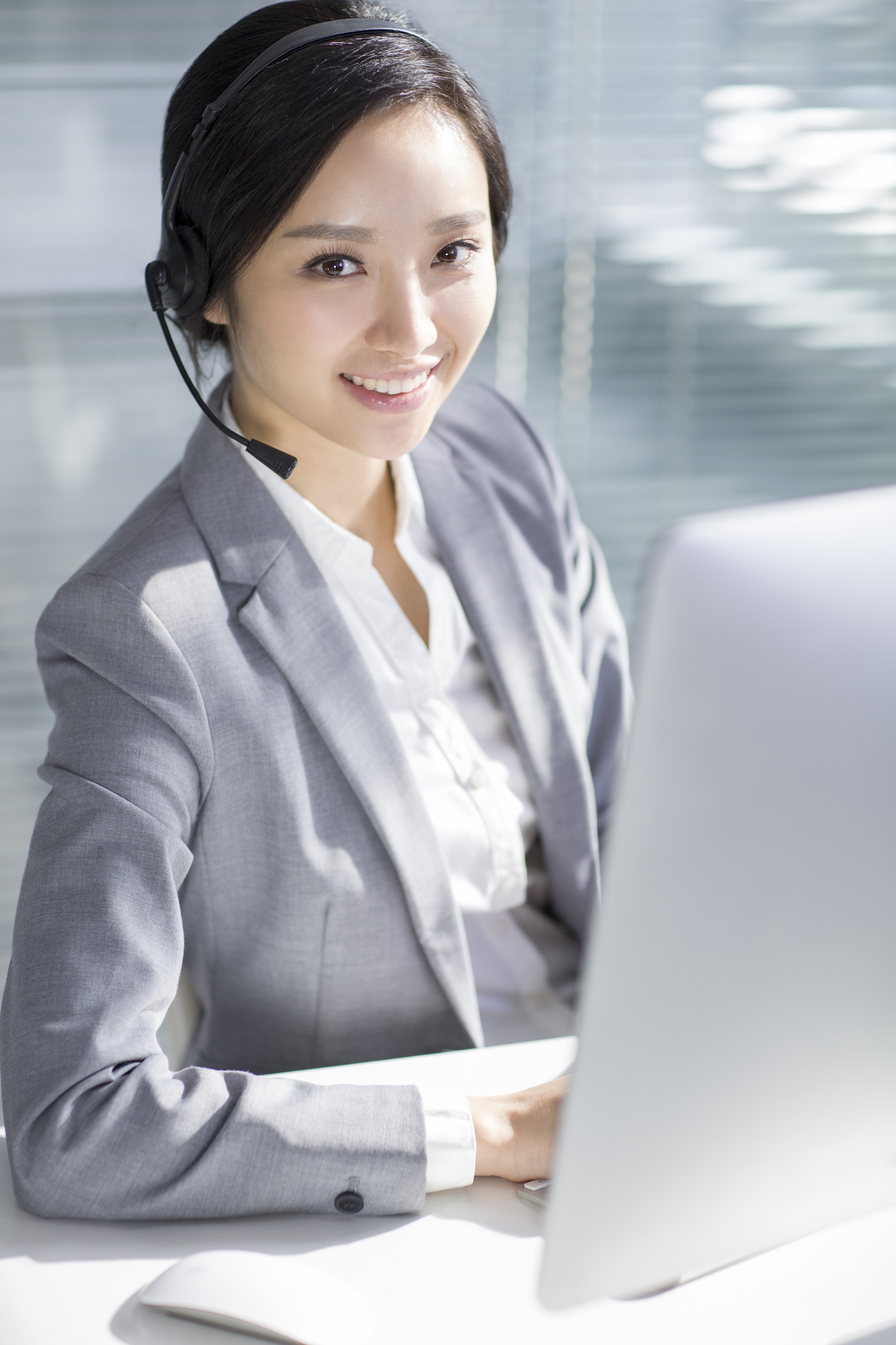 Chinese businesswoman working in office with headset